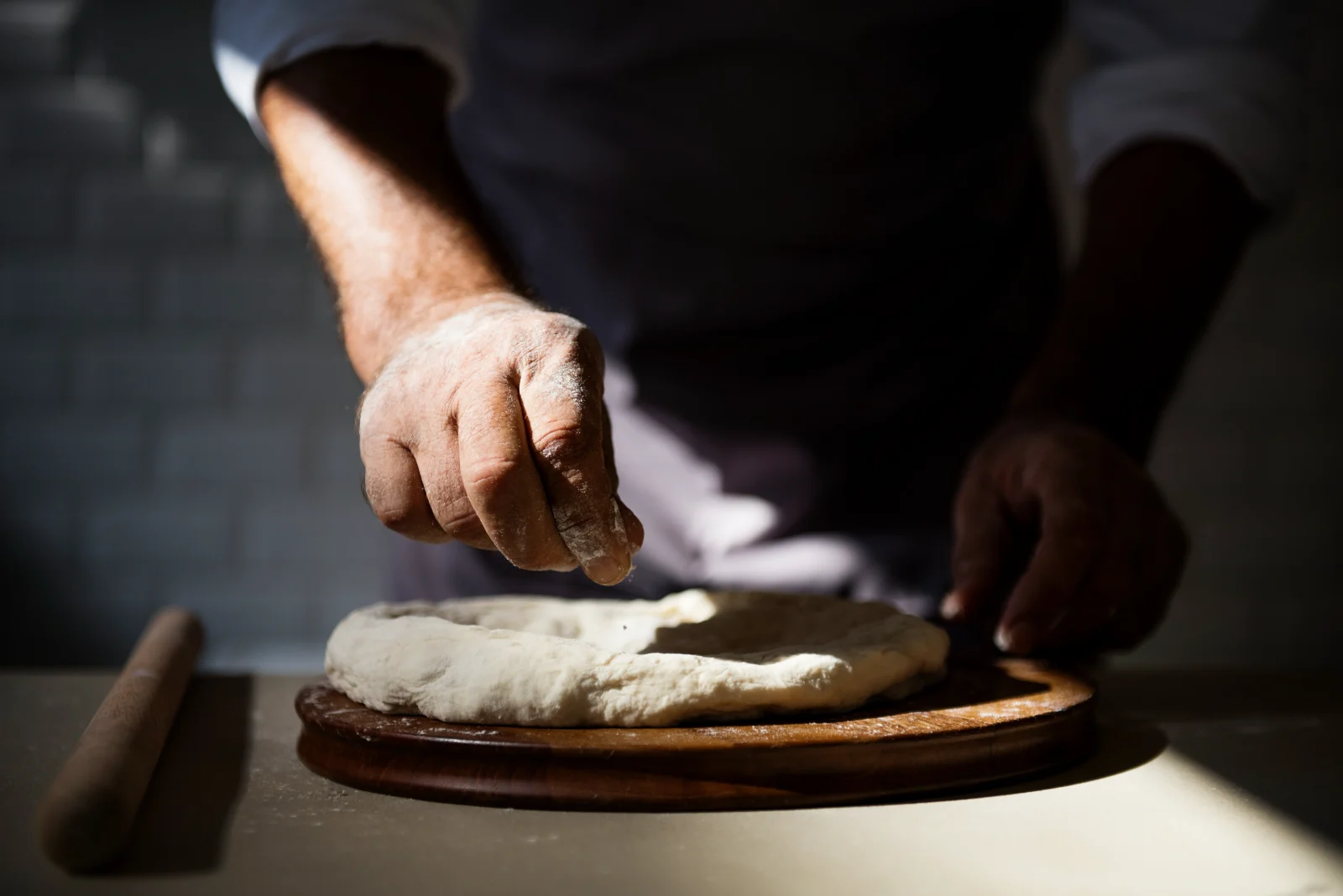 Baker's hands shaping dough, typical b roll footage for a bakery story