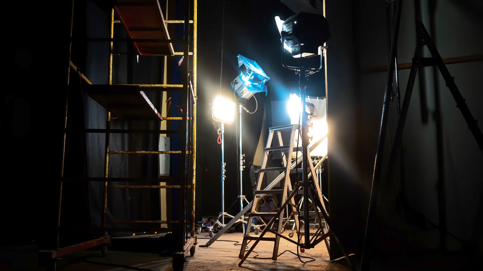 Rows of film lights glowing on a dark movie set