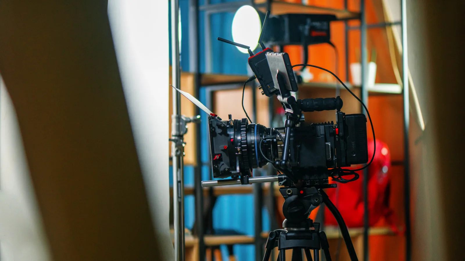 Cinema camera on a tripod on a lit studio set, the core tool of cinematography